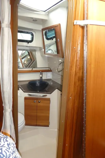 Second Act Yacht Photos Pics 2021 Ranger Tugs R-29 S bathroom with wood accents and modern fixtures.