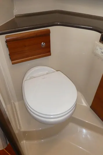 Second Act Yacht Photos Pics 2021 Ranger Tugs R-29 S boat bathroom with modern toilet and wooden accents.