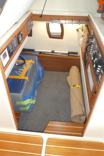 Second Act Yacht Photos Pics 2021 Ranger Tugs R-29 S interior cabin with control panels and storage space.