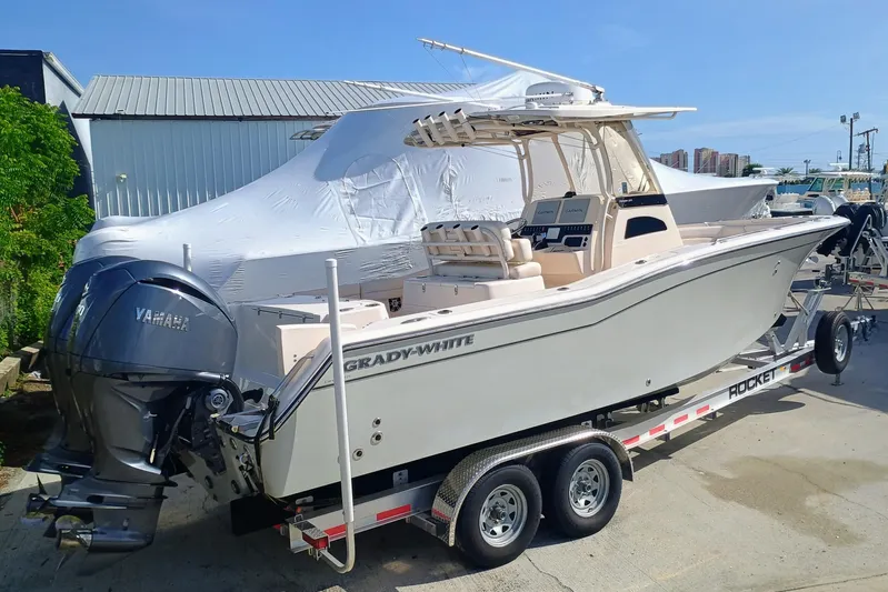 271-508 Brokerage Joe Yacht Photos Pics 2023 Grady-White Canyon 271 boat on trailer with Yamaha engines, parked outdoors.