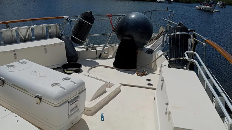 Revanche II Yacht Photos Pics 1986 Hatteras 53 Extended Deckhouse Motor Yacht deck with storage and safety equipment.