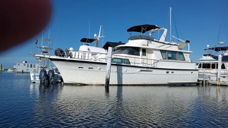 Revanche II Yacht Photos Pics 1986 Hatteras 53 Extended Deckhouse Motor Yacht docked in a marina.