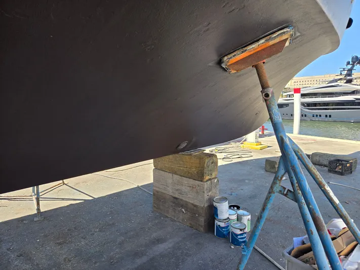 Revanche II Yacht Photos Pics 1986 Hatteras 53 Extended Deckhouse yacht under maintenance, supported by stands and blocks.