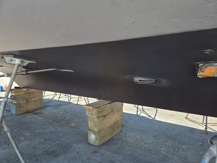 Revanche II Yacht Photos Pics 1986 Hatteras 53 Extended Deckhouse hull on blocks, under maintenance.