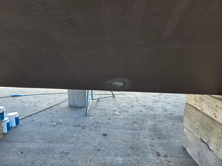 Revanche II Yacht Photos Pics Bottom view of a 1986 Hatteras 53 Extended Deckhouse hull with visible dent.