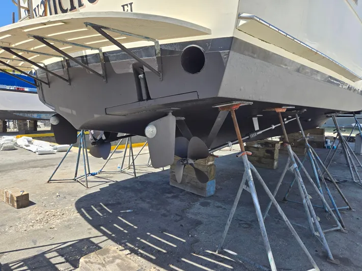 Revanche II Yacht Photos Pics 1986 Hatteras 53 Extended Deckhouse yacht on dry dock, showing propellers and hull.