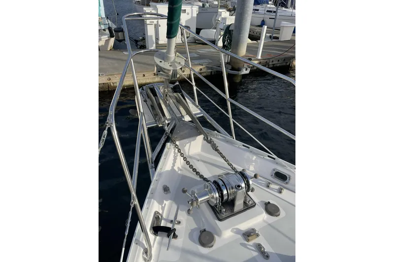 Skimmer Yacht Photos Pics Bow of 2000 Valiant 42 sailboat with anchor chain and winch at marina.