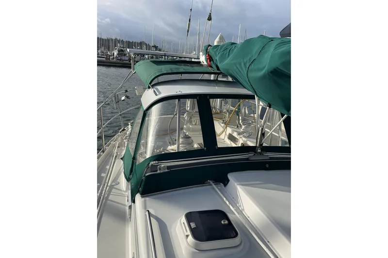 Skimmer Yacht Photos Pics Sailboat Valiant 42, 2000 model, with green canopy docked at marina.