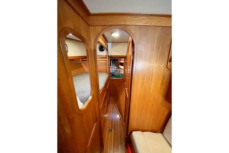Skimmer Yacht Photos Pics Interior of 2000 Valiant 42 sailboat with wooden paneling and cozy cabin space.