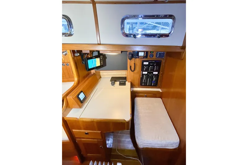 Skimmer Yacht Photos Pics Navigation station in 2000 Valiant 42 yacht with control panel and seating.