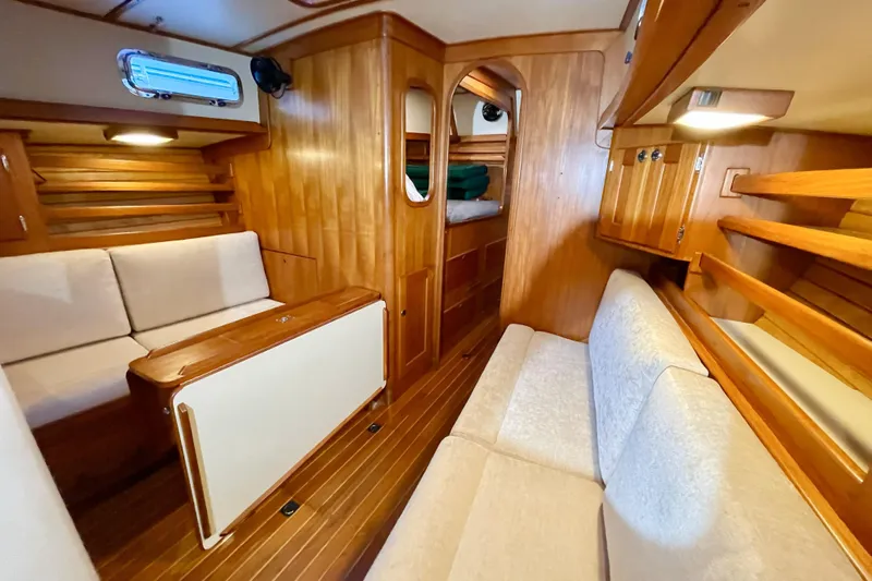 Skimmer Yacht Photos Pics Luxurious 2000 Valiant 42 yacht interior with wooden finish and comfortable seating.