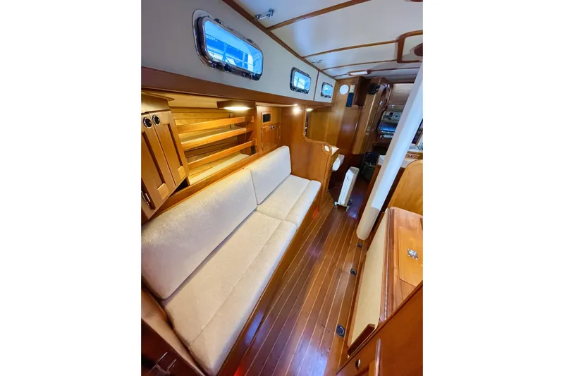 Skimmer Yacht Photos Pics Luxurious interior of 2000 Valiant 42 yacht with wooden finish and cozy seating.