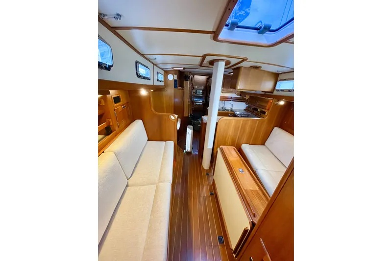 Skimmer Yacht Photos Pics Interior of 2000 Valiant 42 sailboat with wooden finish and cozy seating.