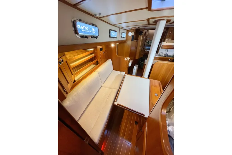 Skimmer Yacht Photos Pics Interior of 2000 Valiant 42 sailboat with wooden finish and cozy seating area.