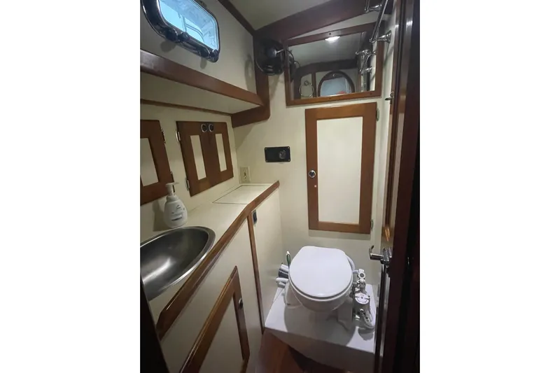 Skimmer Yacht Photos Pics Valiant 42 yacht bathroom, 2000 model, featuring sink, toilet, and wooden accents.