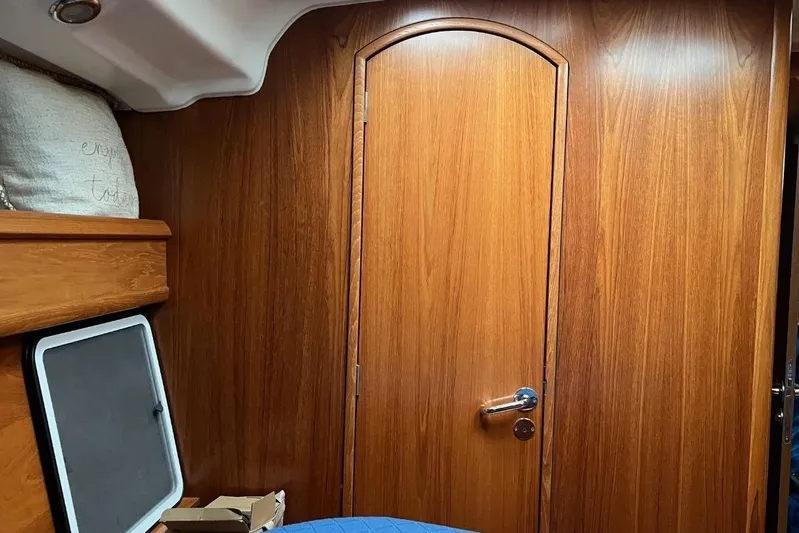 Arrow Yacht Photos Pics Interior of 2008 Jeanneau Sun Odyssey 45 sailboat with wooden paneling and cozy cabin.