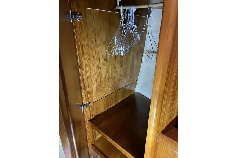Arrow Yacht Photos Pics Wooden closet interior with hangers on Jeanneau Sun Odyssey 45, 2008 model.