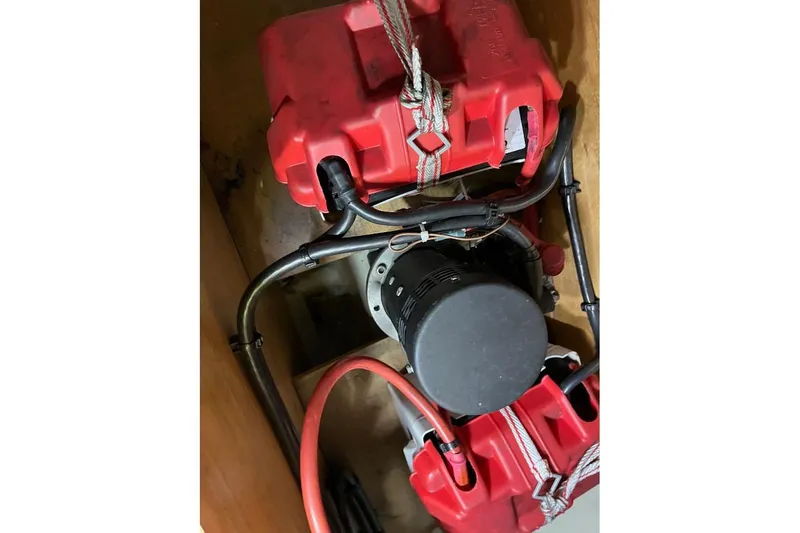 Arrow Yacht Photos Pics Engine compartment of 2008 Jeanneau Sun Odyssey 45 with red fuel tanks and hoses.