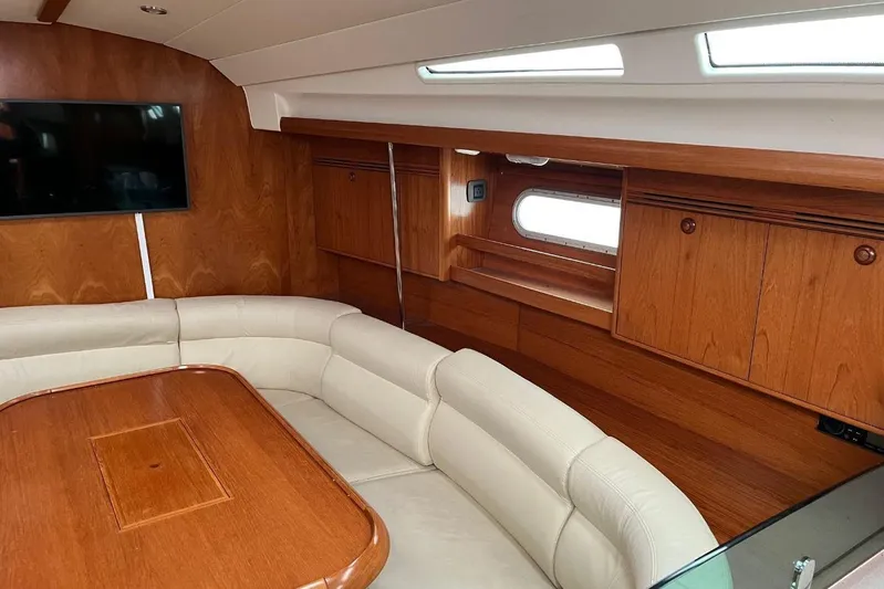Arrow Yacht Photos Pics Luxurious interior of 2008 Jeanneau Sun Odyssey 45 yacht with wood finish and seating area.