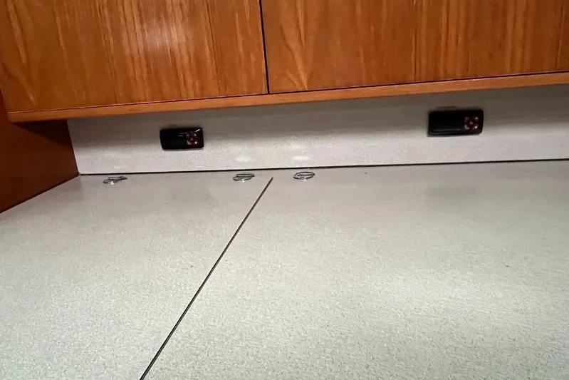 Arrow Yacht Photos Pics Interior of 2008 Jeanneau Sun Odyssey 45 yacht with wooden cabinetry and sleek countertop.