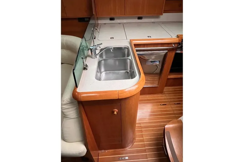 Arrow Yacht Photos Pics Interior of 2008 Jeanneau Sun Odyssey 45 yacht, featuring a compact kitchen sink area.