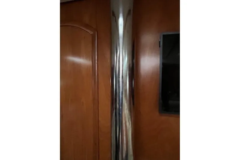 Arrow Yacht Photos Pics Interior of 2008 Jeanneau Sun Odyssey 45 yacht with polished metal and wooden paneling.