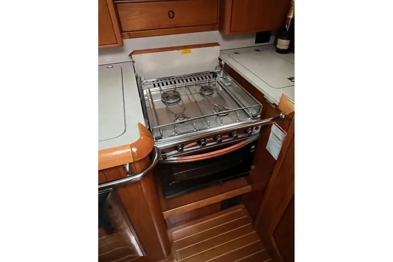 Arrow Yacht Photos Pics Galley kitchen in 2008 Jeanneau Sun Odyssey 45 sailboat with stove and oven.