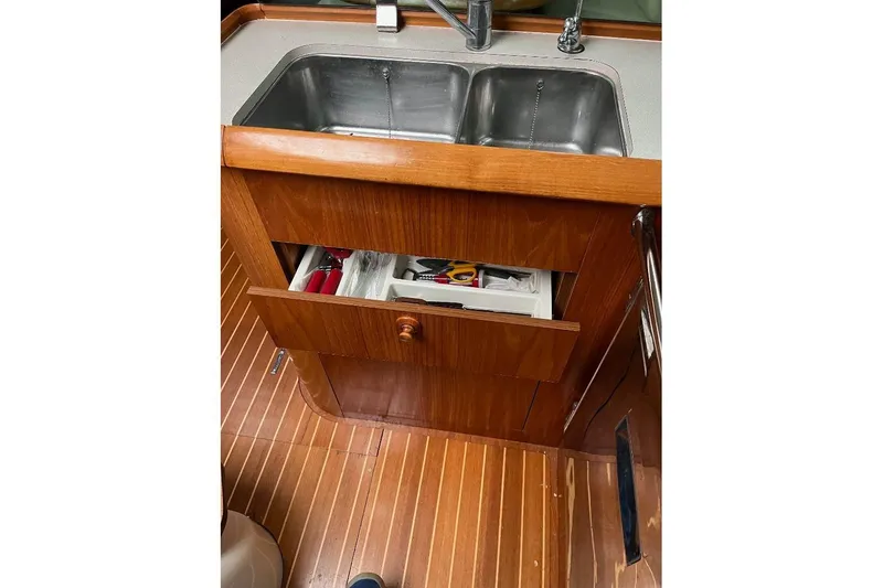Arrow Yacht Photos Pics Wooden kitchen area with sink and open drawer on Jeanneau Sun Odyssey 45, 2008 model.