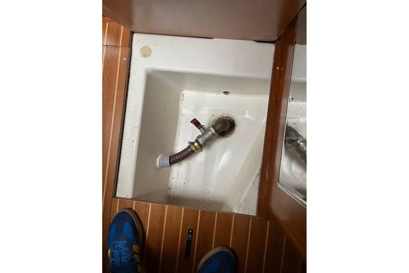 Arrow Yacht Photos Pics Interior view of 2008 Jeanneau Sun Odyssey 45 sailboat showing plumbing and wooden flooring.