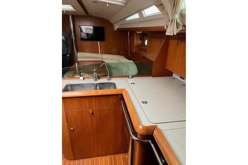 Arrow Yacht Photos Pics Interior of 2008 Jeanneau Sun Odyssey 45 yacht with wooden cabinetry and modern amenities.