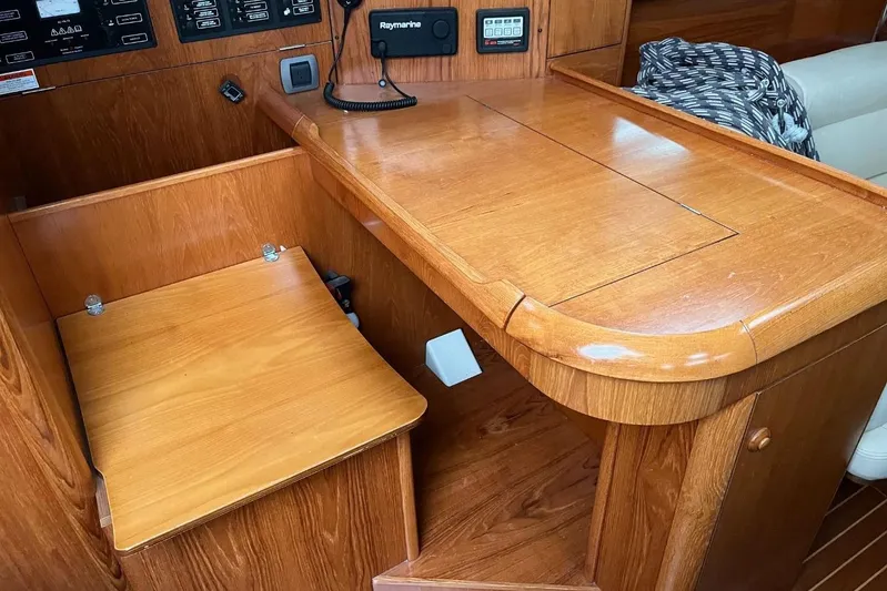 Arrow Yacht Photos Pics 2008 Jeanneau Sun Odyssey 45 interior with wooden navigation station and control panels.
