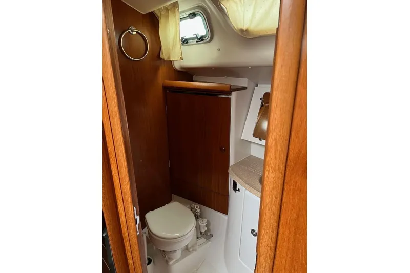 Arrow Yacht Photos Pics Interior of 2008 Jeanneau Sun Odyssey 45 yacht bathroom with wooden cabinetry.