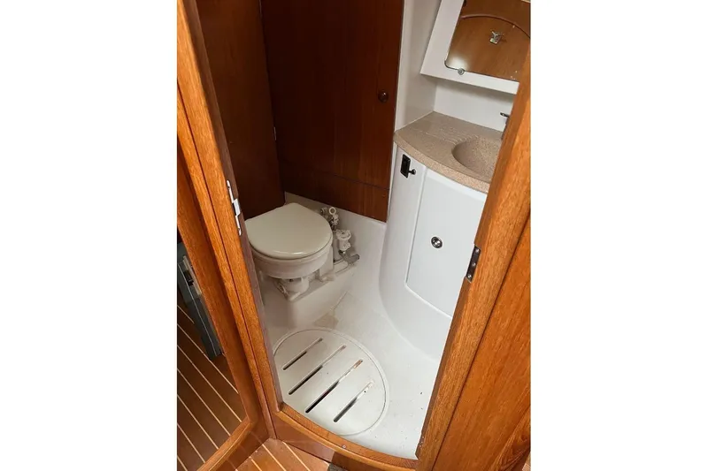 Arrow Yacht Photos Pics Bathroom interior of 2008 Jeanneau Sun Odyssey 45 yacht, featuring toilet and sink.