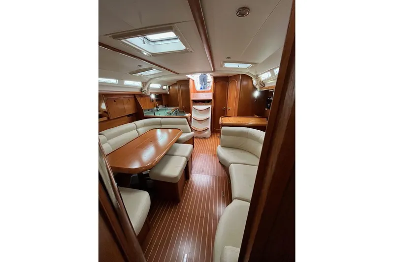 Arrow Yacht Photos Pics Interior of 2008 Jeanneau Sun Odyssey 45 yacht with elegant wood finish and seating area.