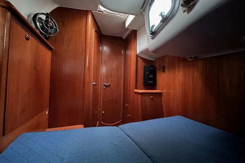 Arrow Yacht Photos Pics Cozy cabin interior of 2008 Jeanneau Sun Odyssey 45 sailboat with wooden finish.
