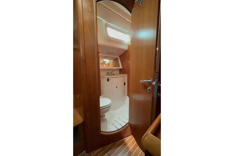 Arrow Yacht Photos Pics Interior of 2008 Jeanneau Sun Odyssey 45 yacht bathroom with wooden finish.