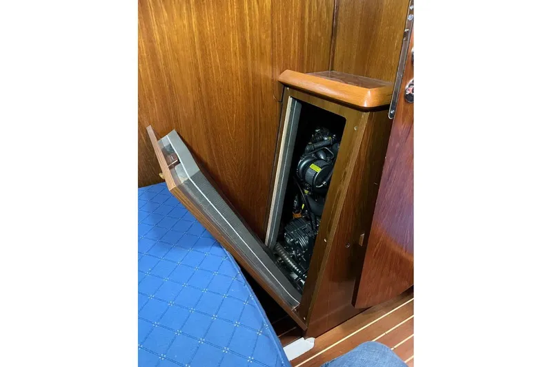 Arrow Yacht Photos Pics Engine compartment of 2008 Jeanneau Sun Odyssey 45 sailboat, with wooden paneling.