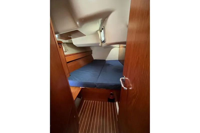 Arrow Yacht Photos Pics Cozy cabin interior of 2008 Jeanneau Sun Odyssey 45 sailboat with wooden finishes.