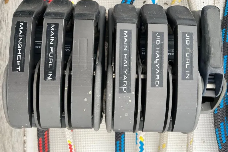 Arrow Yacht Photos Pics Sailing controls on a 2008 Jeanneau Sun Odyssey 45, labeled for mainsheet and halyards.