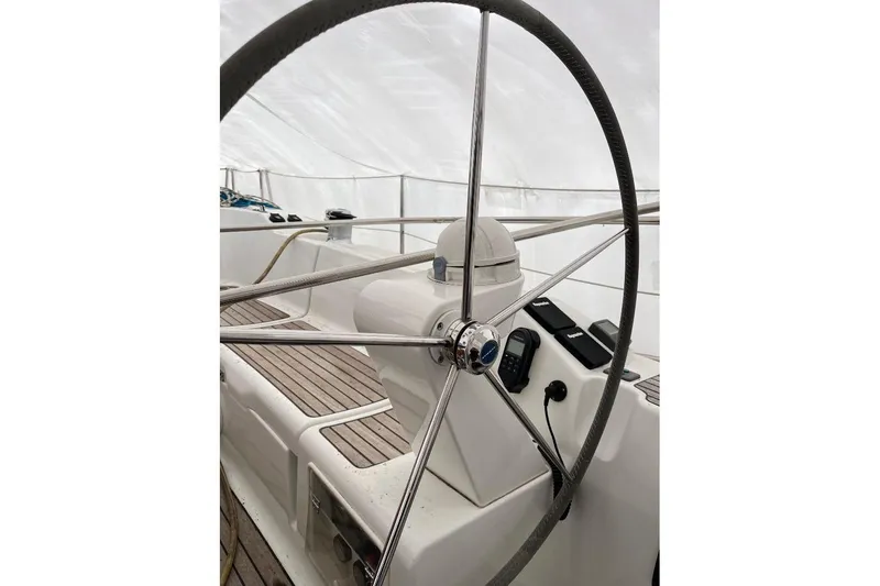 Arrow Yacht Photos Pics Steering wheel of 2008 Jeanneau Sun Odyssey 45 sailboat, featuring sleek design and navigation instruments.