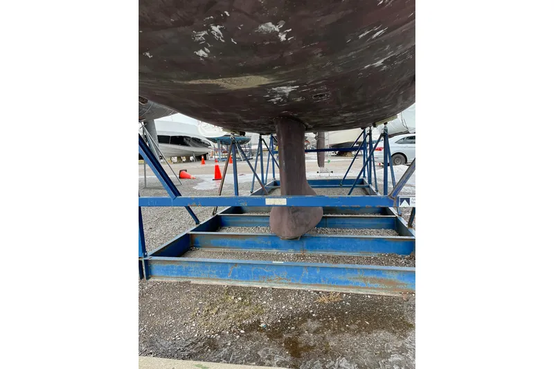 Arrow Yacht Photos Pics Keel of 2008 Jeanneau Sun Odyssey 45 sailboat on blue metal stands.