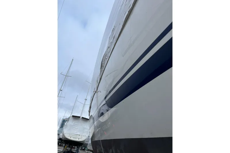 Arrow Yacht Photos Pics 2008 Jeanneau Sun Odyssey 45 sailboat, side view, in a marina with overcast sky.