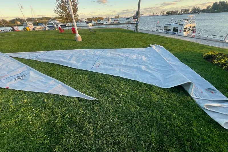 Arrow Yacht Photos Pics Sail from 2008 Jeanneau Sun Odyssey 45 yacht laid out on grass by marina.