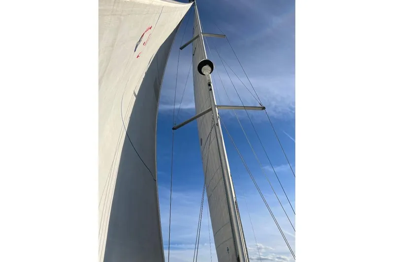 Arrow Yacht Photos Pics Sailing mast and sails of 2008 Jeanneau Sun Odyssey 45 against blue sky.