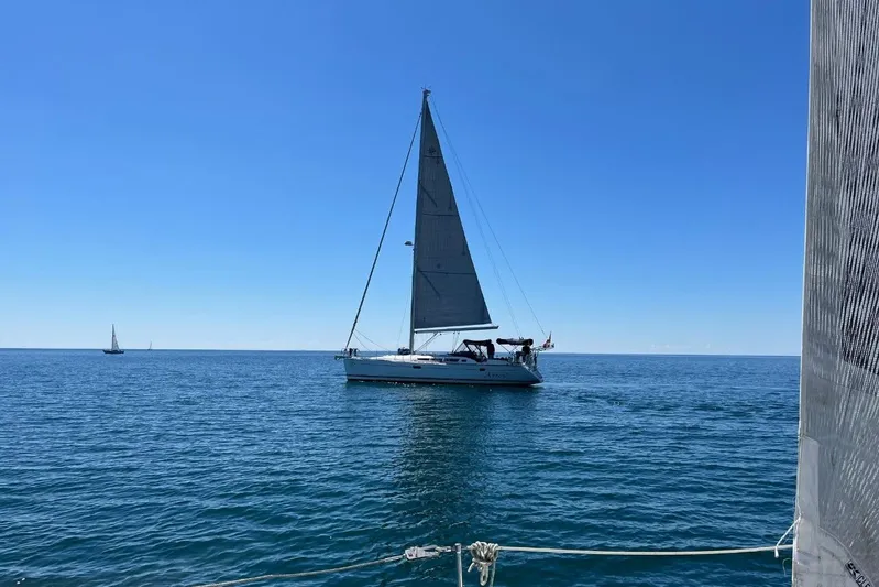 Arrow Yacht Photos Pics Sailboat Jeanneau Sun Odyssey 45, 2008 model, cruising on calm blue sea under clear sky.