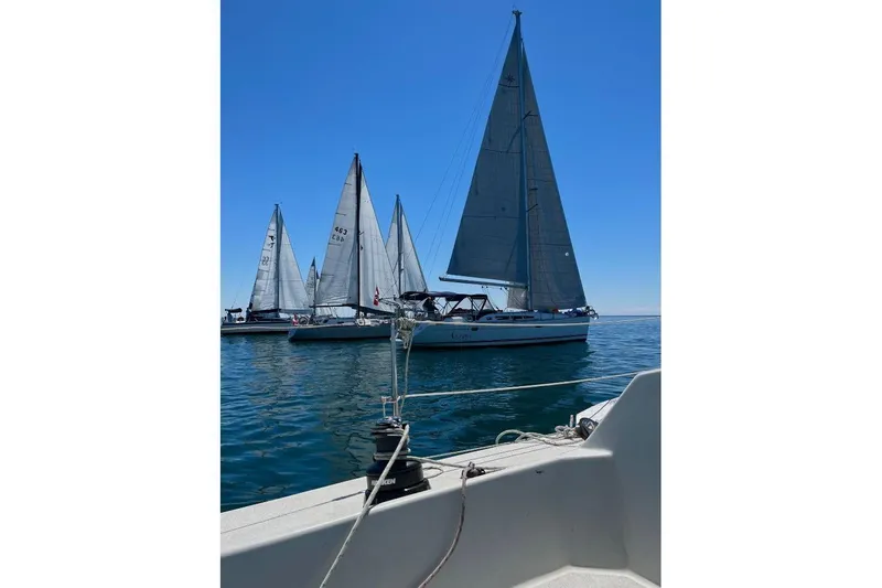 Arrow Yacht Photos Pics Sailboats on calm water, featuring a 2008 Jeanneau Sun Odyssey 45 under clear blue skies.