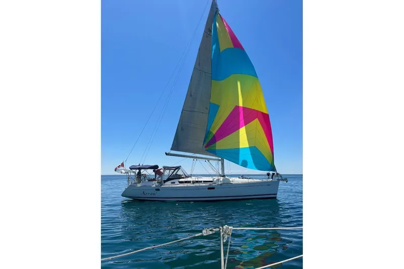 Arrow Yacht Photos Pics Jeanneau Sun Odyssey 45 sailboat, 2008 model, with colorful sails on open water.