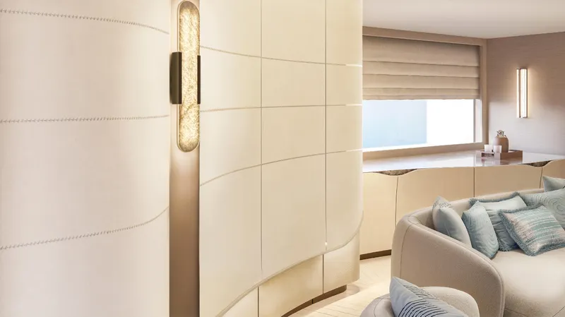  Yacht Photos Pics Luxurious interior of ISA Sportiva 66 yacht, 2027, featuring elegant curved walls and plush seating.