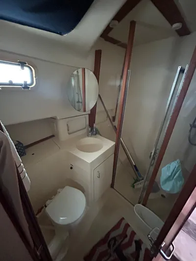  Yacht Photos Pics 1999 Mainship 350 Trawler bathroom with shower, sink, and toilet.
