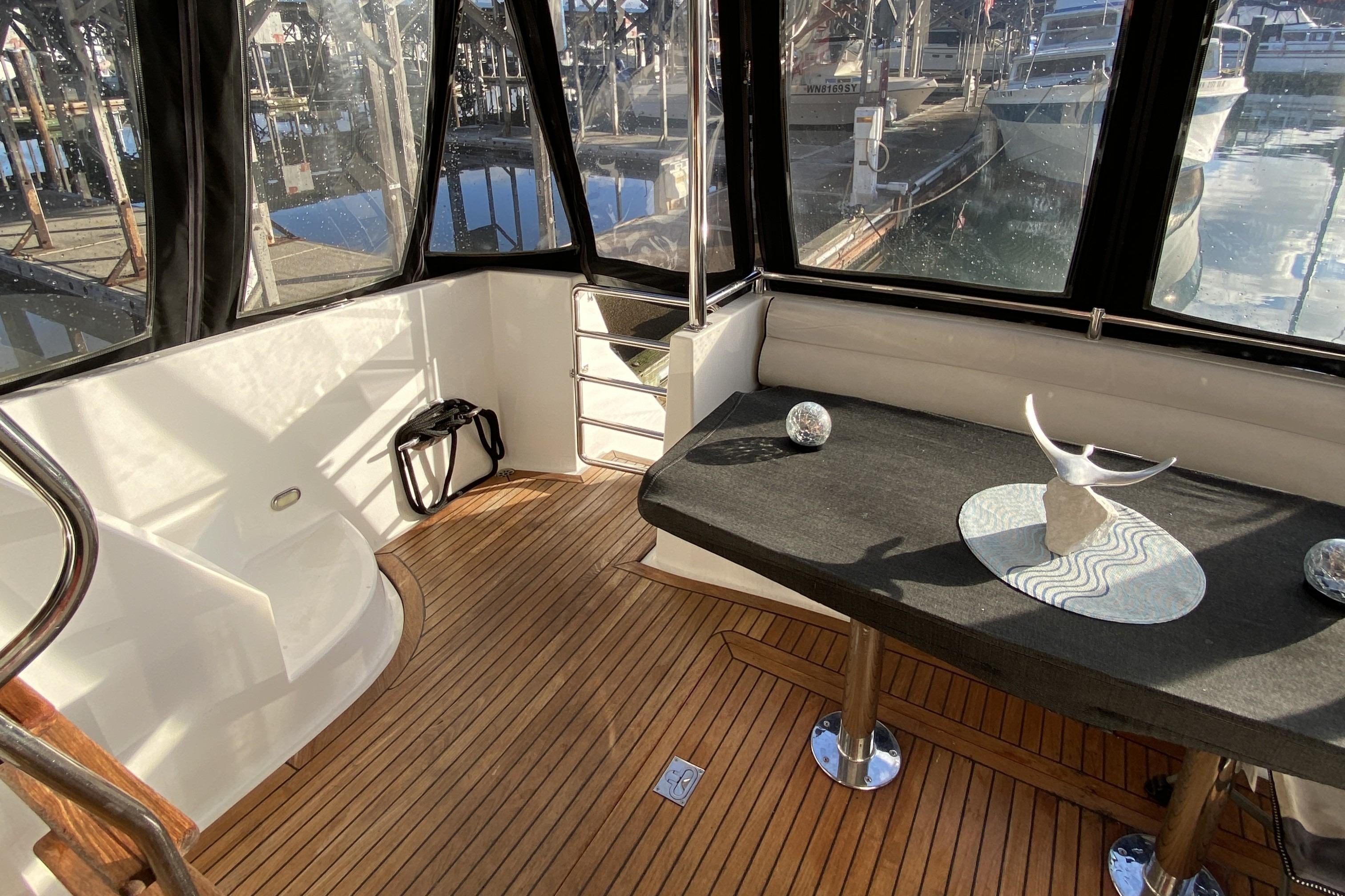 Interior of 2000 Compass 55 yacht with wooden flooring and modern decor.